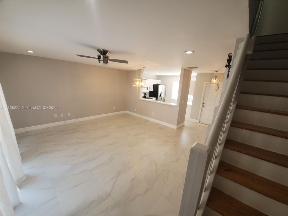 living/dining room area view front bottom of stairs.