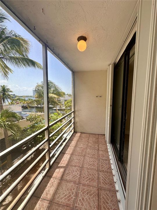 Screened balcony with accordion shutters