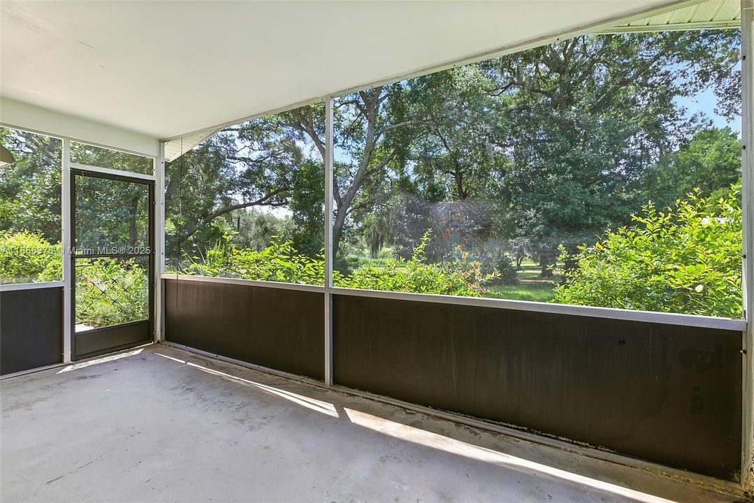 Screened in porch / view to backyard & lake