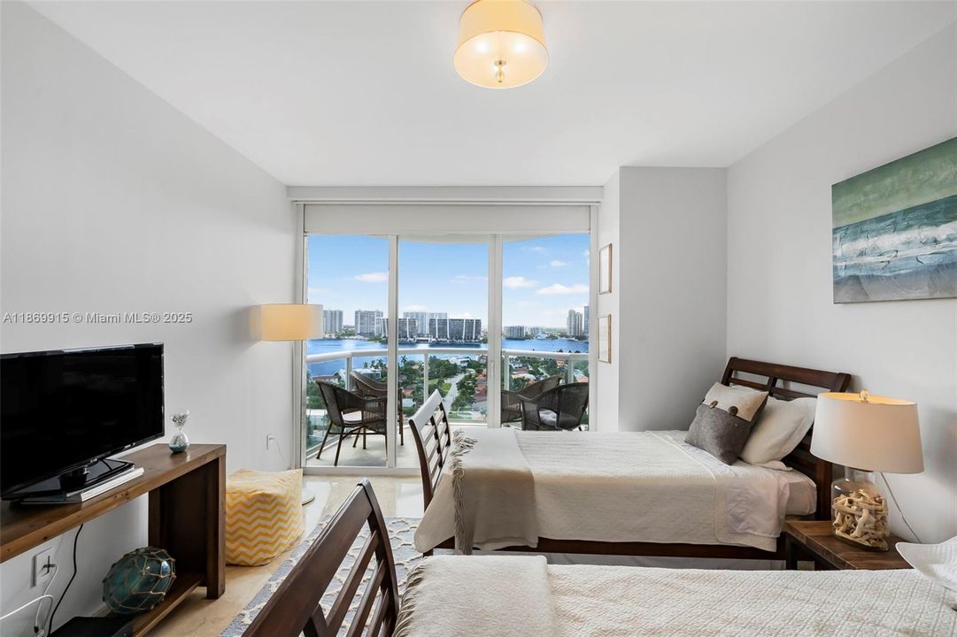 SECOND BEDROOM AND BALCONY WITH BEAUTIFUL INTRACOASTAL VIEWS.