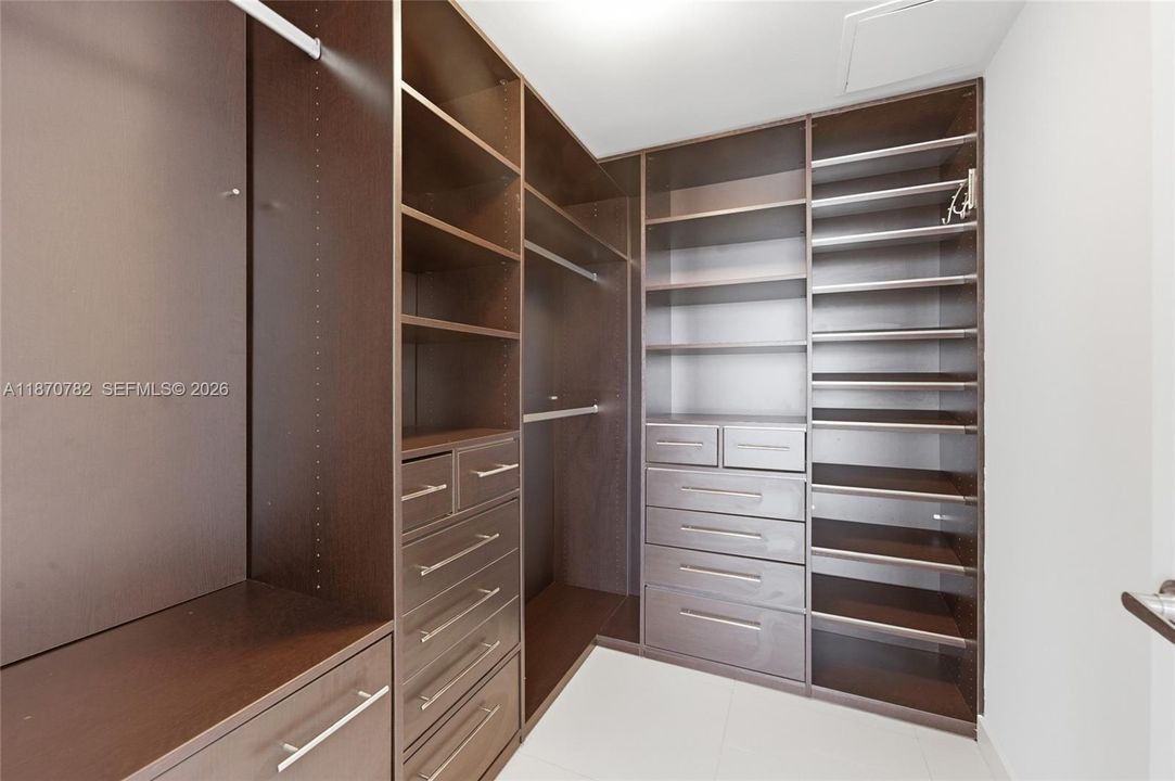 Walk-in closet with custom built ins & safe!
