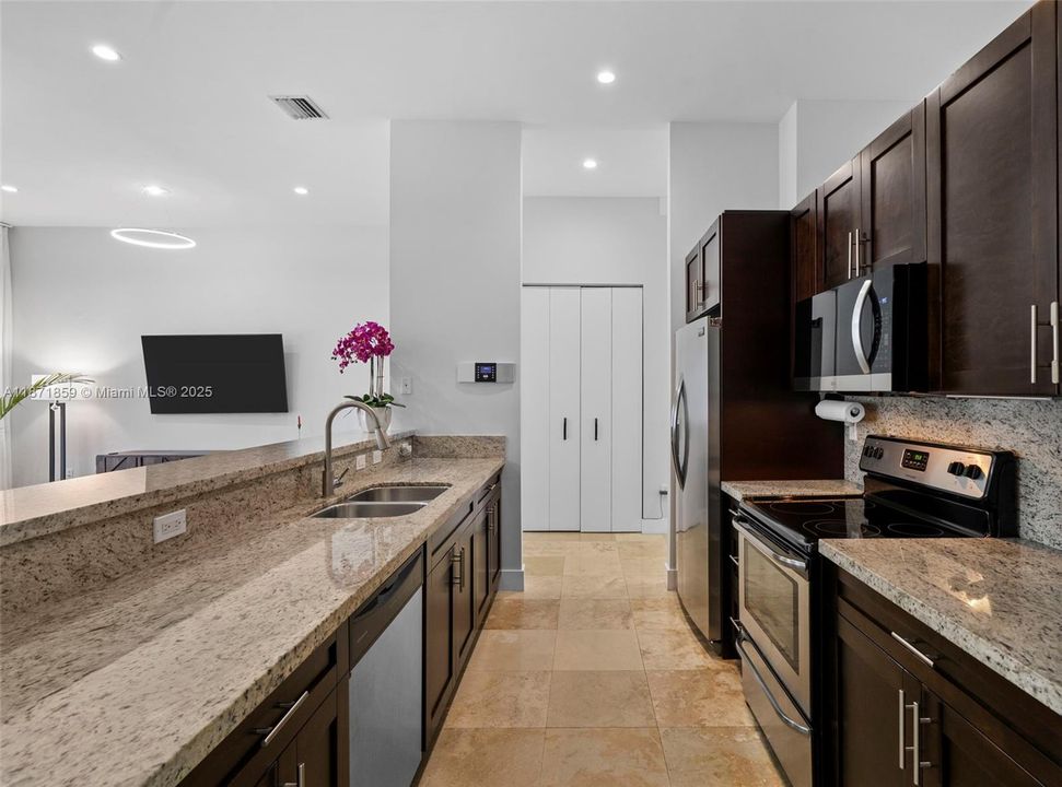 Gourmet kitchen with granite countertops and breakfast bar