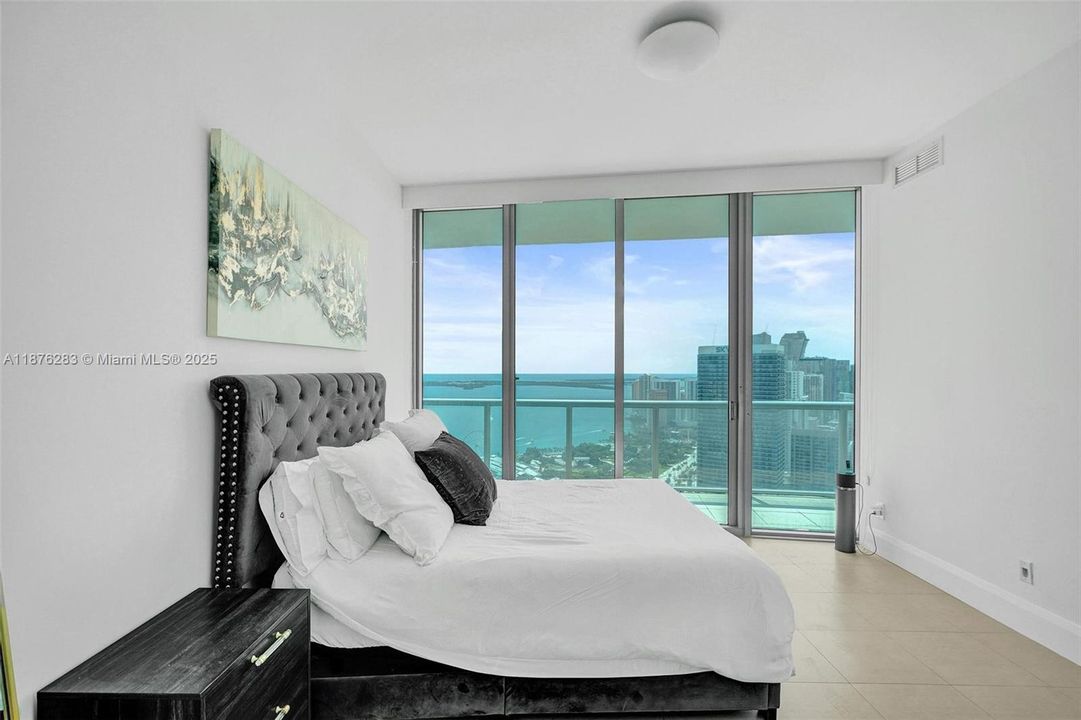 Direct balcony access from the primary suite lets you enjoy stunning water views right from bed.
