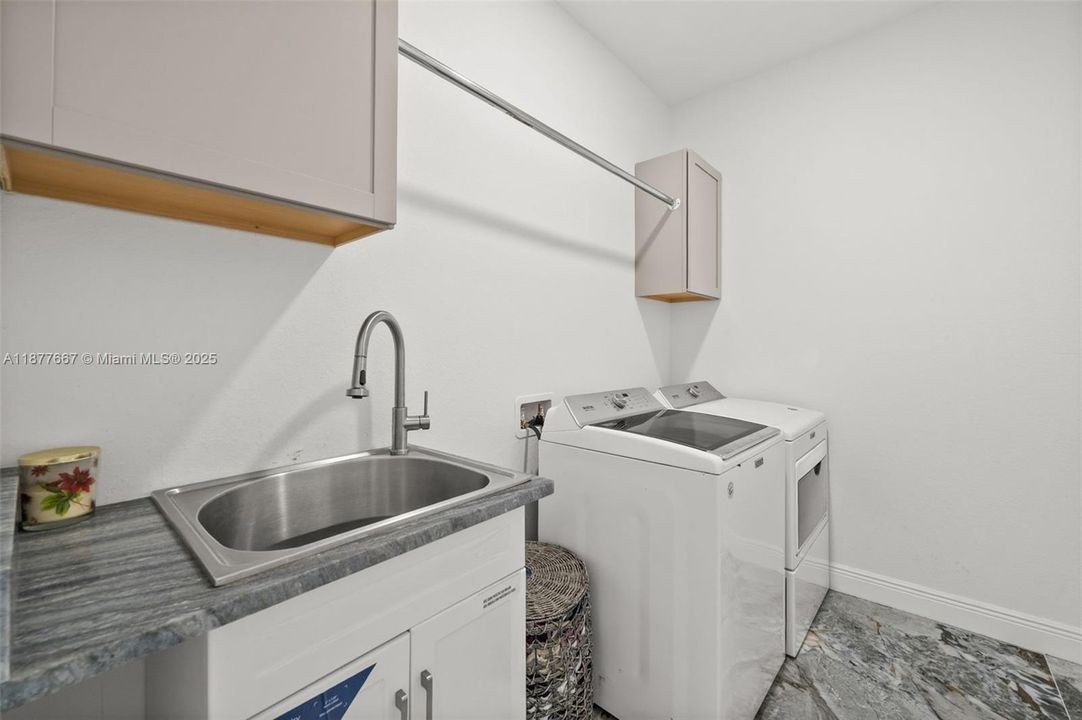 Laundry room with sink and storage