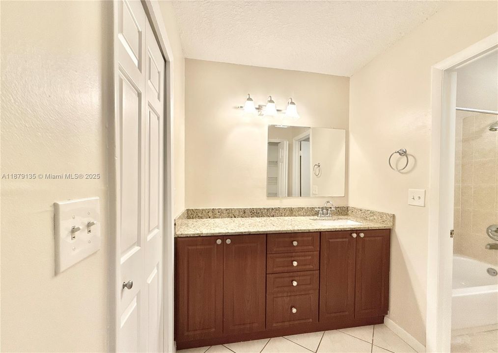 walk-in Closet to the left and toilet and shower on the right.