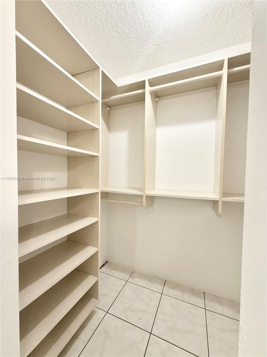 another photo of the walk-in closet of the primary bedroom