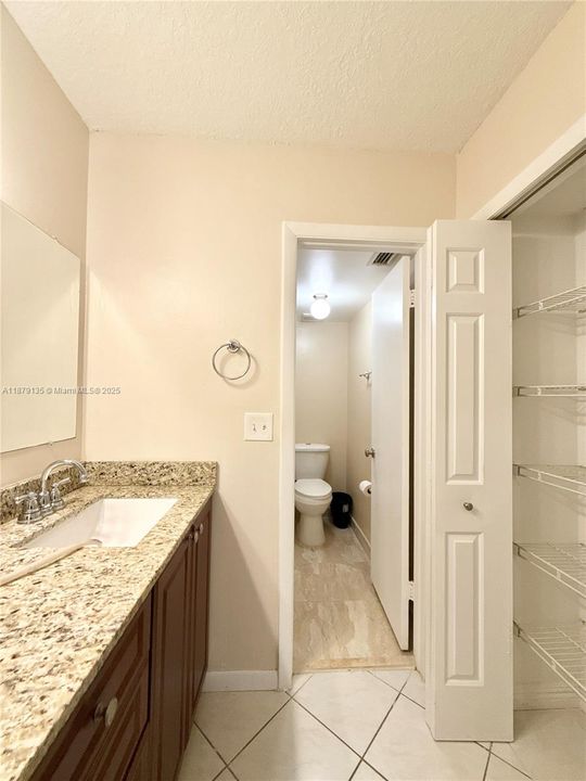 linen closet across from the primary bathroom sink