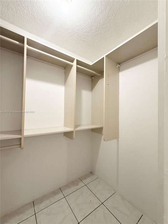 inside the walk-in closet in the primary bedroom