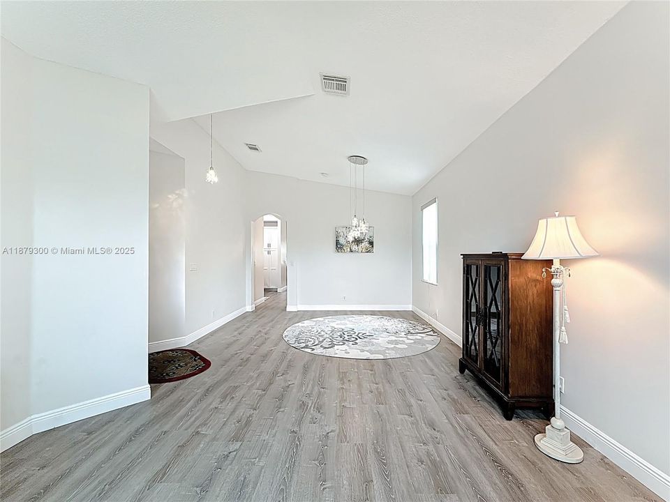 Dining room and living room combined in front part of the home with luxury vinyl flooring