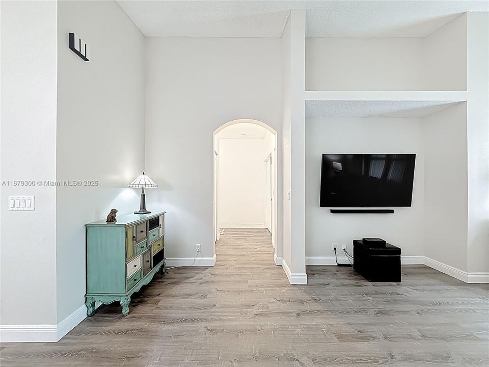 Family room with hallway leading to four bedrooms