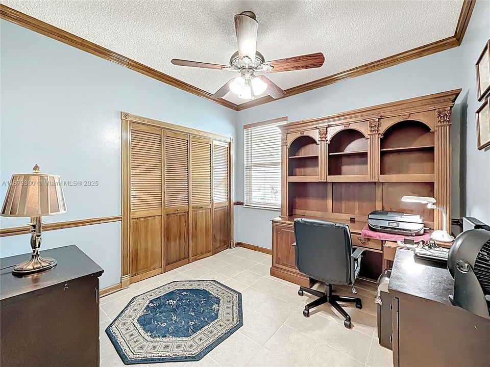 Bedroom used as an office. Beautiful crown molding and base boards