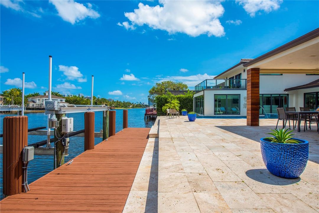 Private boat dock with a lift on a clear, sunny day.