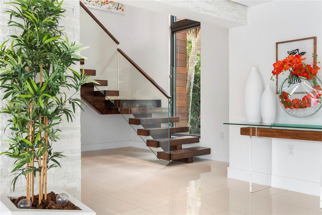 Entry hall with floating stairs and art