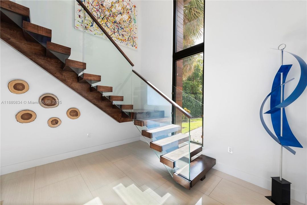 Sculptural staircase with glass rail