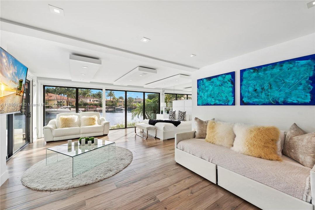 Living space highlighted by vibrant blue and teal abstract art.