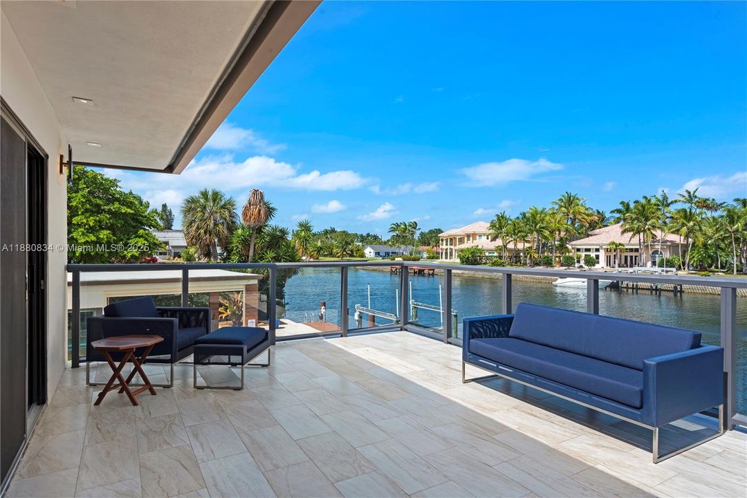 Outdoor patio with a blue sofa and waterfront views.