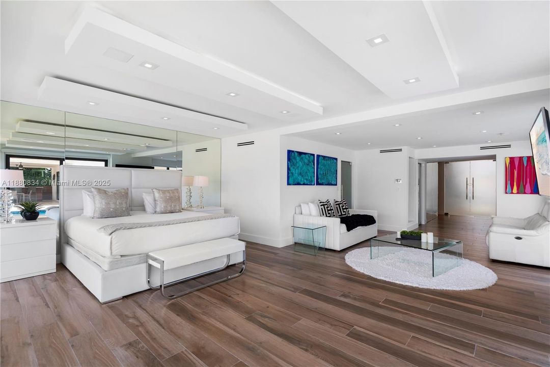 All-white bedroom with a unique ceiling and contemporary design.