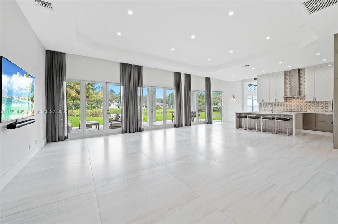 Grand Great Room Living/Dining/Kitchen with 48” x 48” porcelain tile flooring