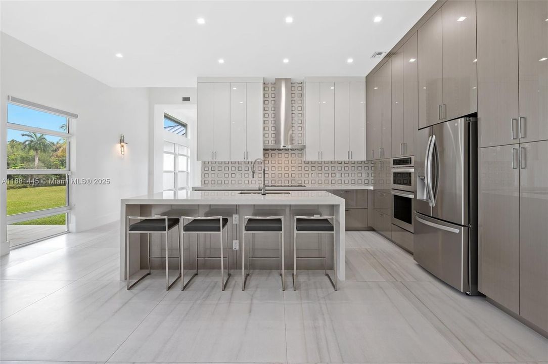 Ceiling-height cabinet and pantry doors with hardwood inserts and under-mounted rails
