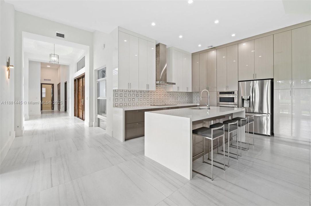 Custom designer kitchen with waterfall quartz island & countertops