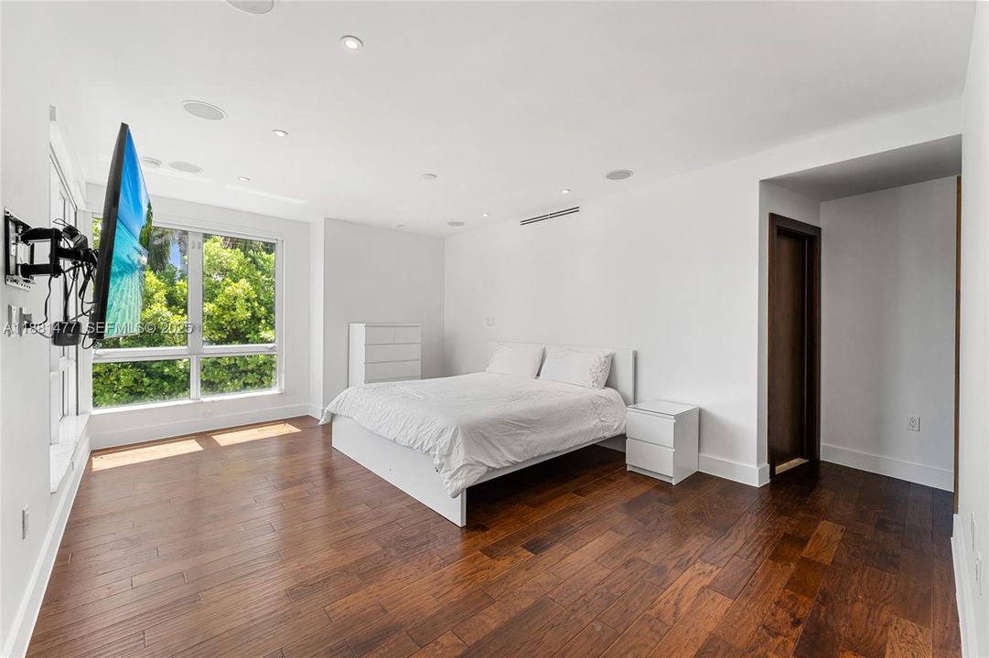 Luxurious Spa-Style with floor to ceiling marble, a soaking tub framed by expansive windows and lush garden views.