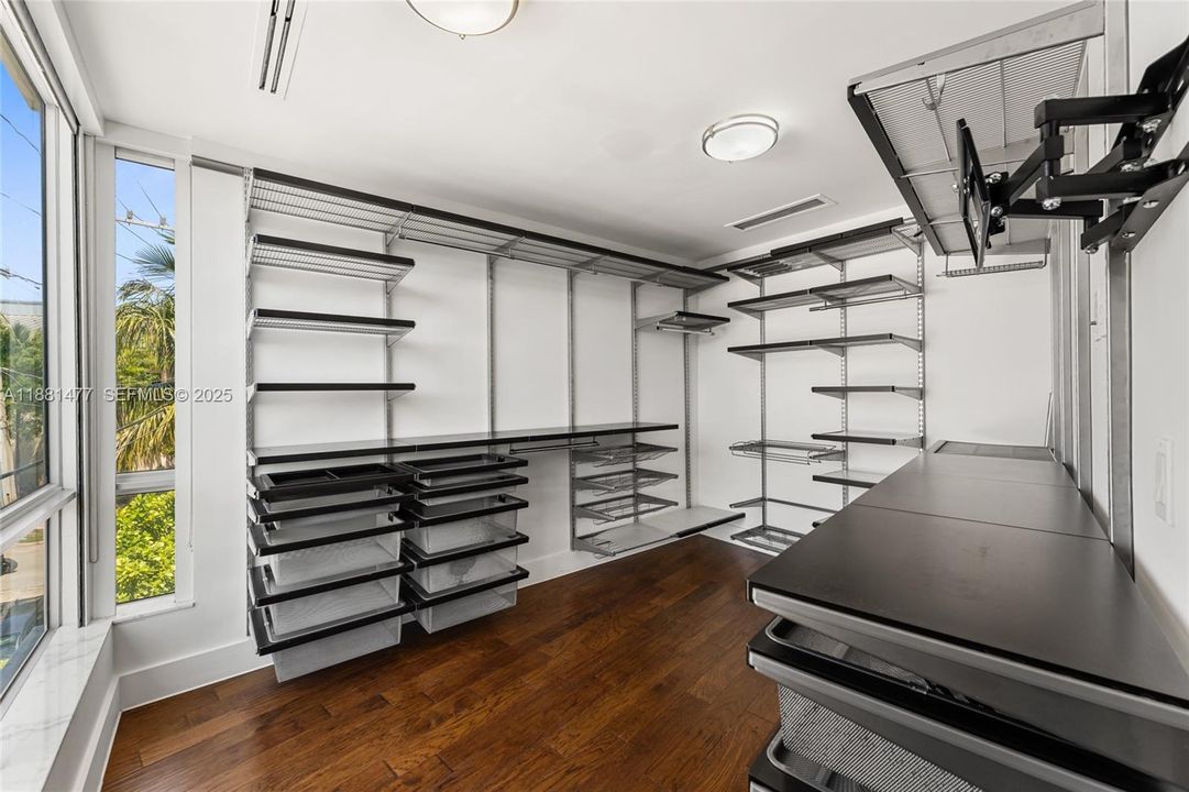 Cozy Bedroom with wood floors and access to private Balcony.