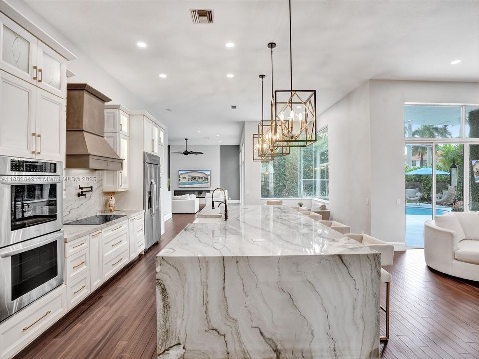 Massive quartzite waterfall island, sleek quartzite countertops.