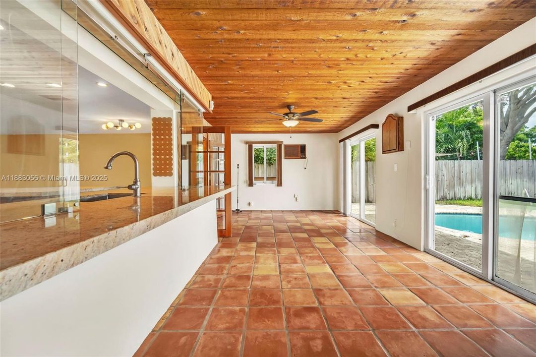 Pass thru from Kitchen.  Sliding doors to Pool.