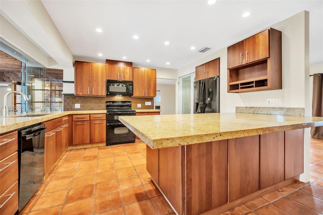 Well-appointed kitchen with 2-sided cabinet in peninsula.