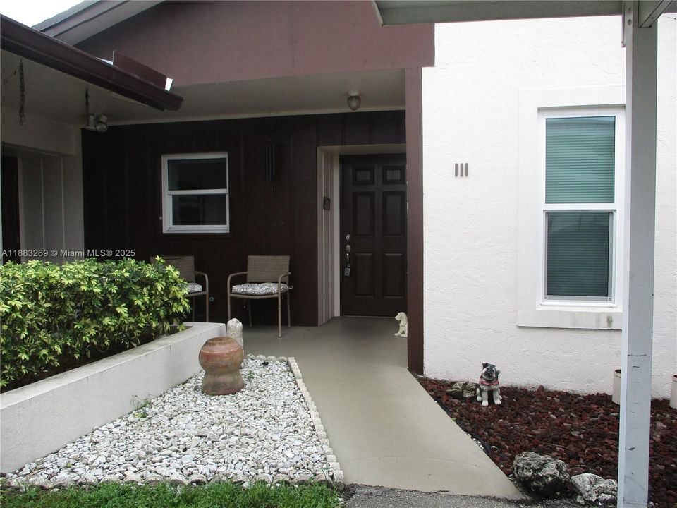 ENTRANCE INTO THE VILLA WITH CARPORT PARKING