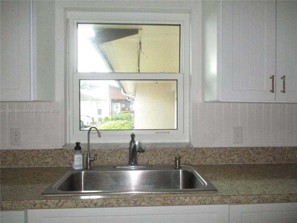 KITCHEN WINDOW OVER THE FULL SIZE STAINLESS STEEL SINK