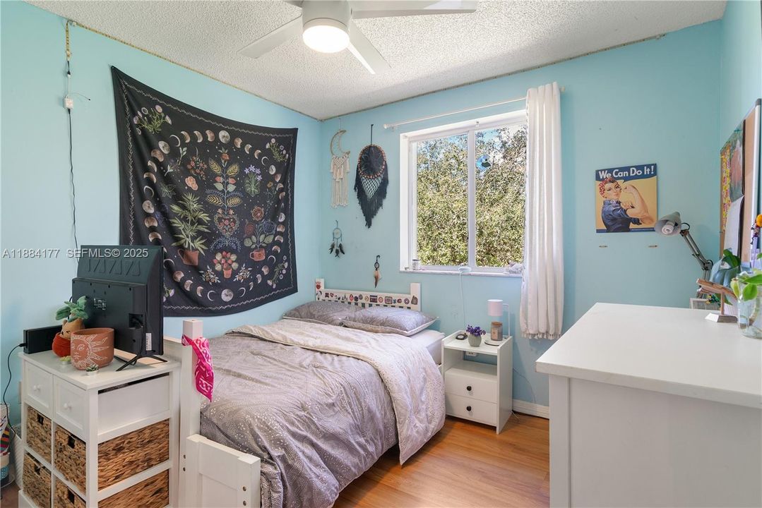 Third large bedroom with nature view and wall-to-wall closet.