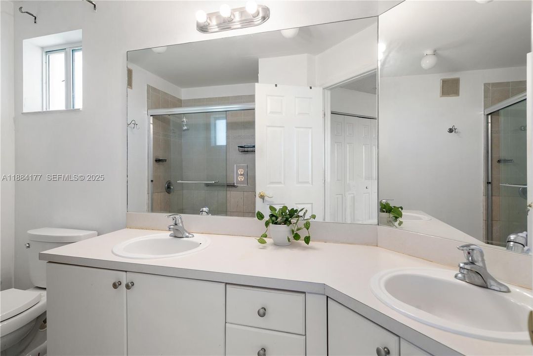 Master bathroom with large shower and dual sinks.