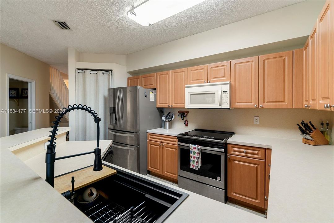 Kitchen with upgraded sink, stylish faucet, and large pantry.