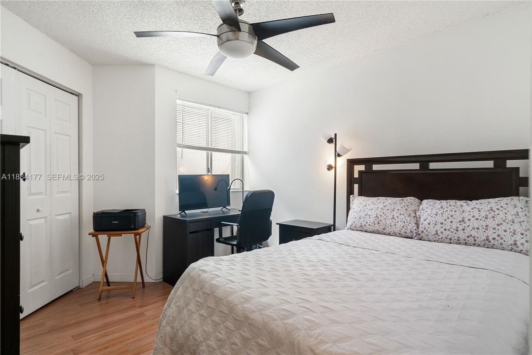 Bright second bedroom with wall-to-wall closet.