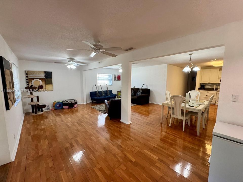 Huge living room, open to family room, open to dining room with covered screen patio at rear.