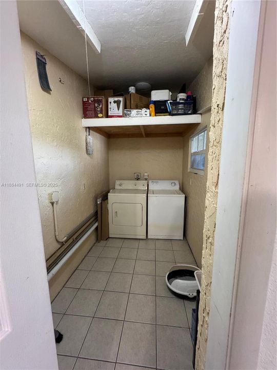 Washer and Dryer in large walk in storage, laundry room.