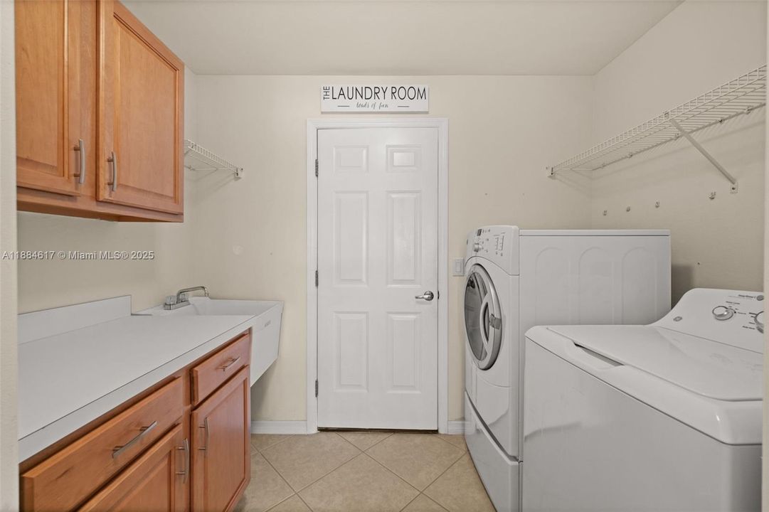 Laundry room with sink and lots of cabinets and counter space