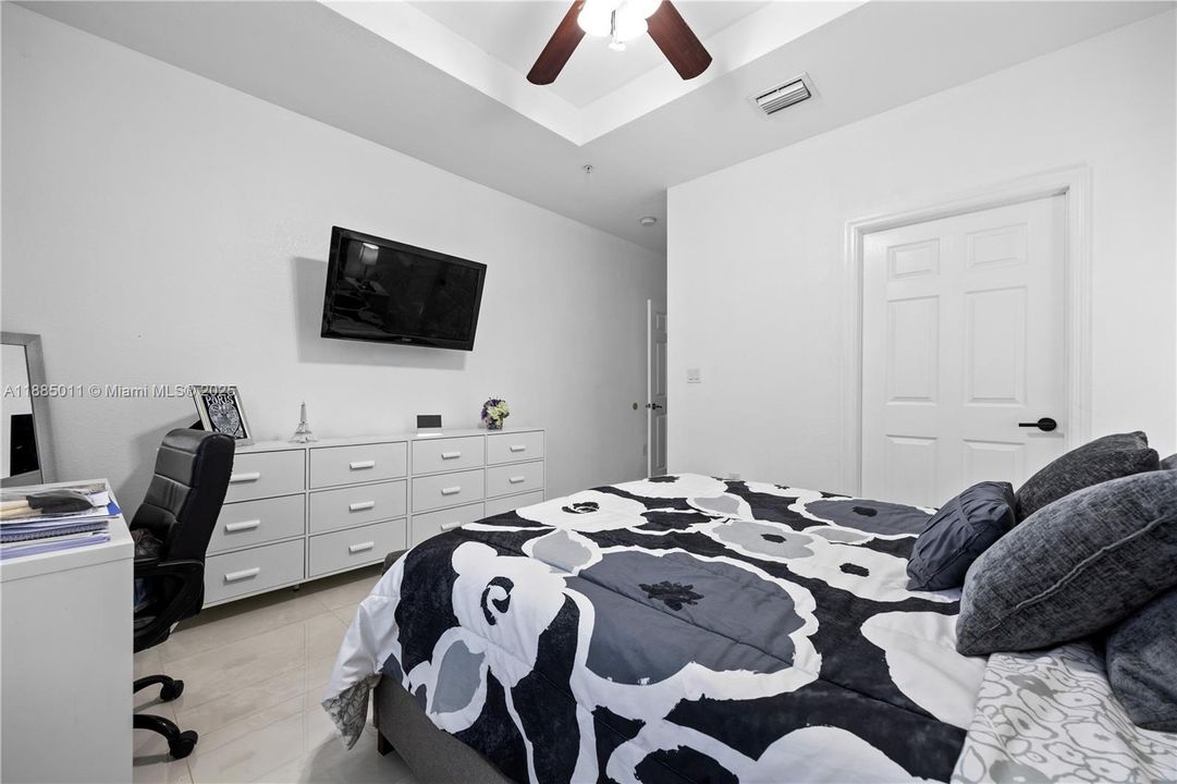 Bedroom with tray ceiling.