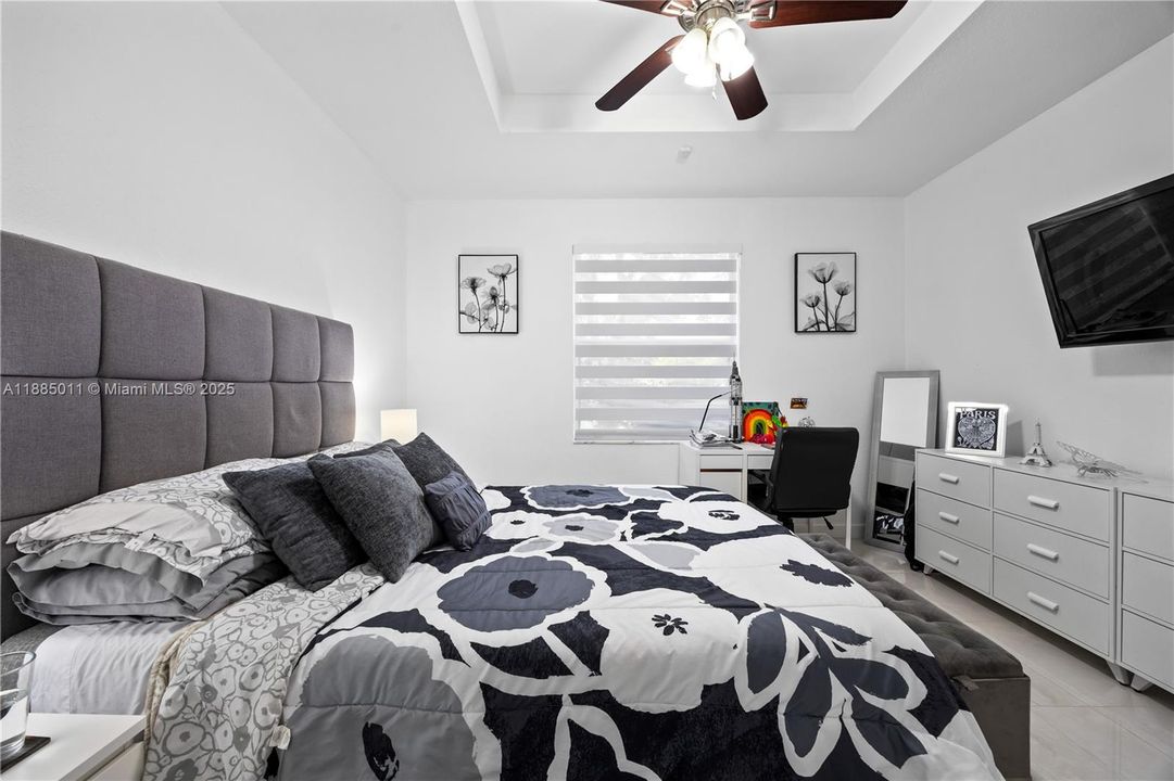 Bedroom with tray ceiling.