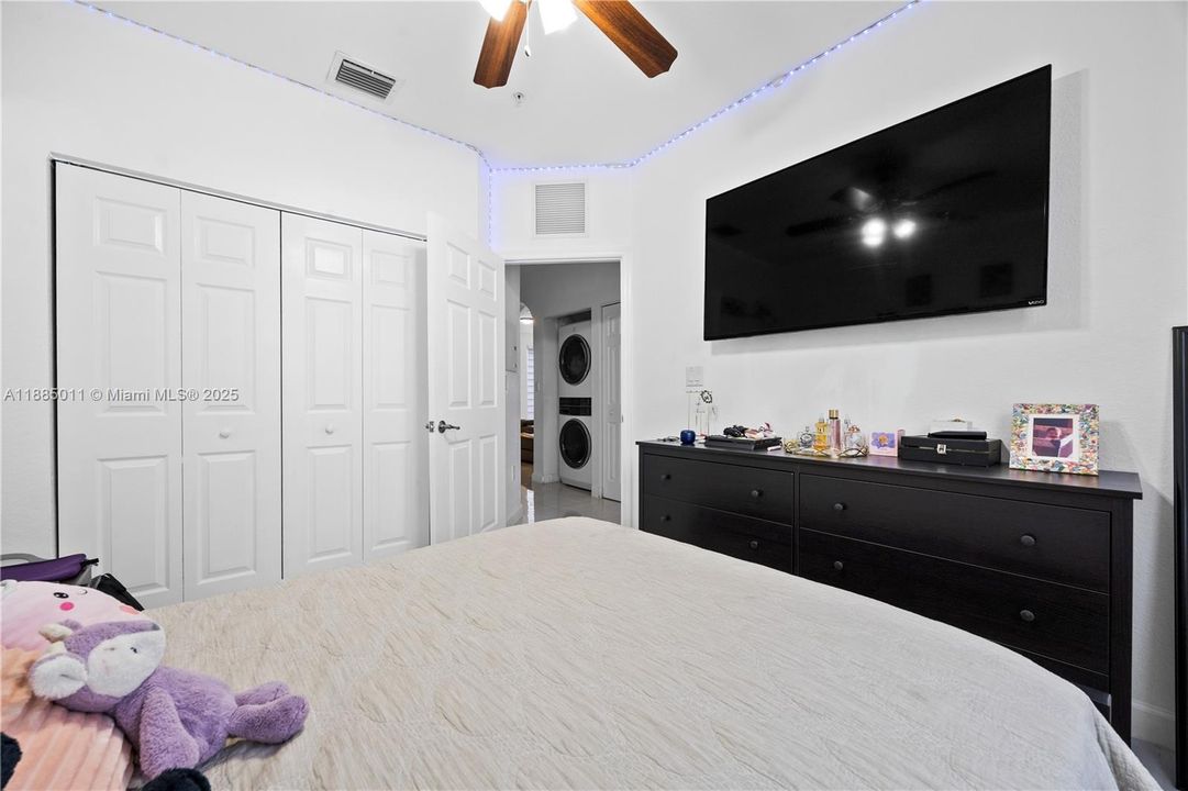 Bedroom with wall-to-wall closet.