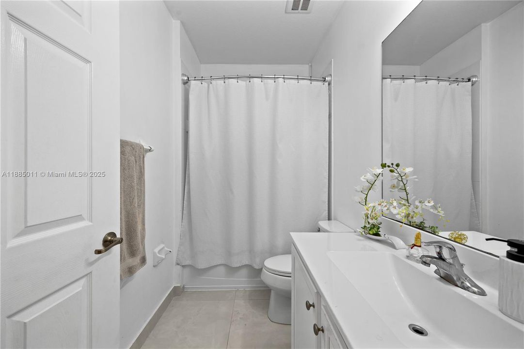 Remodeled bathroom with bathtub.