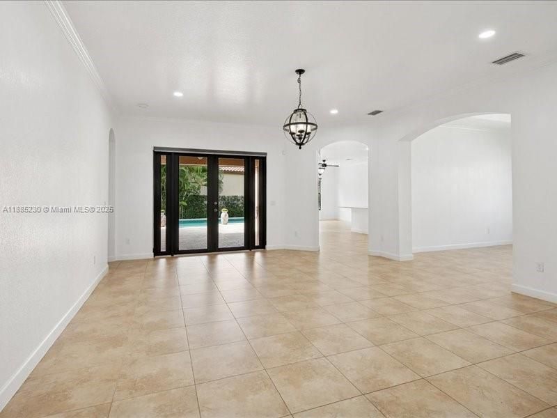 A grand formal living room designed for refined entertaining, framed by soaring ceilings that invite natural light