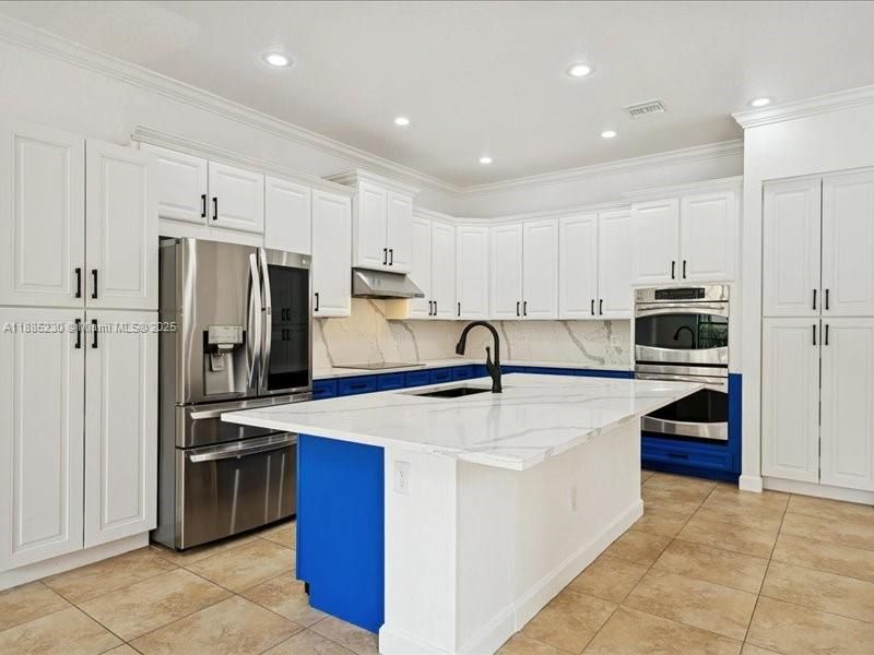 Sophisticated oversized island that anchors the kitchen with style