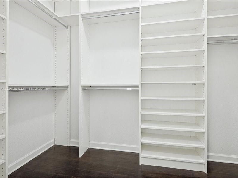 Spacious walk-in closet offering both function and refined style