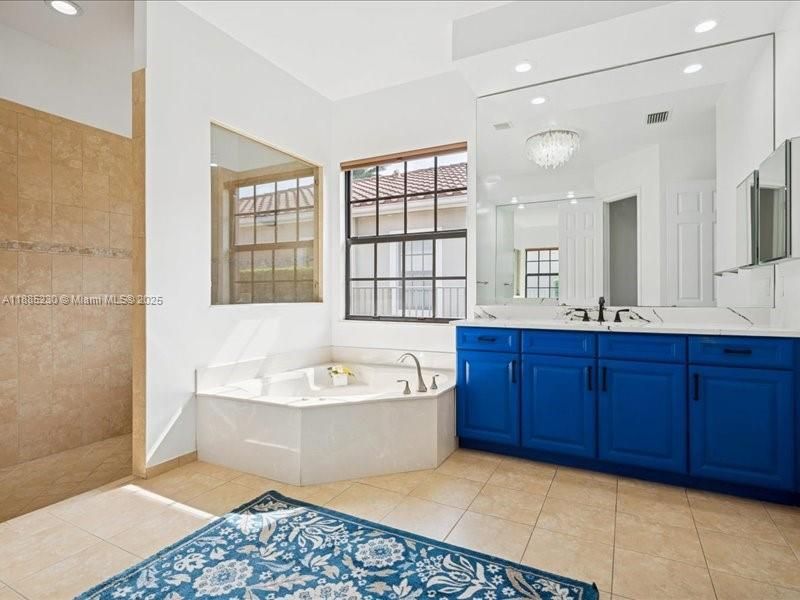 Elegant spa-style bathroom with dual vanities.