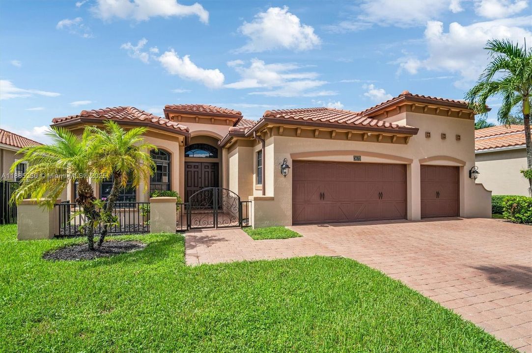 mpressive curb appeal with refined architecture, three-car garage, and beautifully designed paver entry