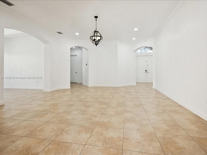 Elegant formal living space with impressive ceiling heights, creating an open and airy ambiance