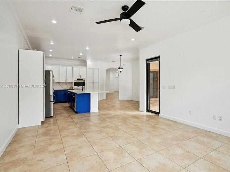 Open-concept family room with seamless views of the kitchen and casual dining area