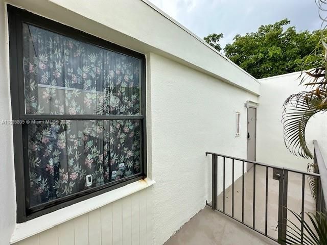 Two windows can provide light and access to view guests that enter.